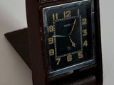 une petite horloge posée sur une table