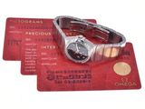 three credit cards with a watch on top of them