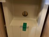 a toilet in a box with a green sticker on it