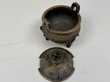 a small metal bowl and a small metal bowl on a table