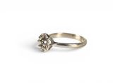 a close up of a silver ring on a white background
