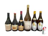 several bottles of wine are lined up on a white surface