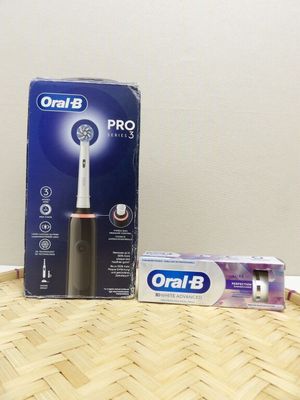 a box of toothbrushes sitting on the floor next to a box of toothpaste