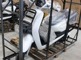 un scooter posé sur une palette dans un entrepôt