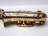 an image of a saxophone with a gold plated body and mouth