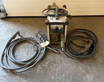 an image of a welding machine and hoses on the floor