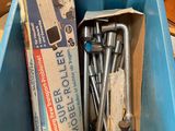une boîte à outils dans un bac bleu posé par terre