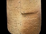 a stone statue of a man with a face on it
