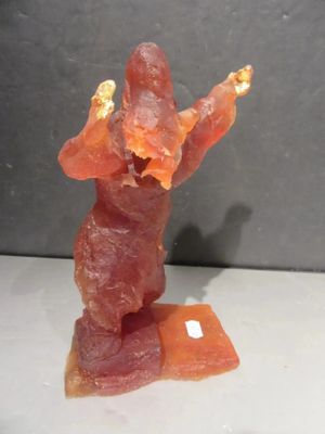 a figurine of a man holding a piece of bacon