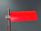 a red lamp that is on top of a table