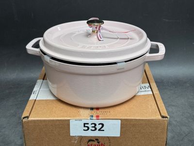 a white pot sitting on top of a cardboard box