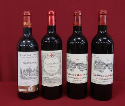 three bottles of red wine are lined up on a table