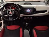the interior of a small car with red and black seats
