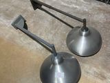 two metal stands on the floor next to each other