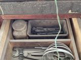 an open drawer with tools in it on a table