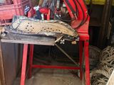 a red work bench with a saw on it in a garage