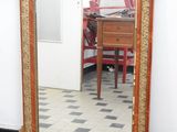a mirror that is sitting on the floor in front of a table