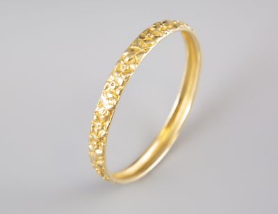 a close up of a gold ring on a white background