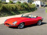 an image of a red sports car parked on the side of the road