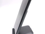 a cell phone on a stand on a white surface