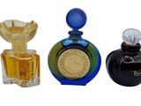 three bottles of perfume sitting next to each other
