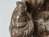 a statue of a woman holding a baby in her arms