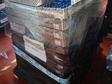 a large stack of mattresses on a pallet in a warehouse