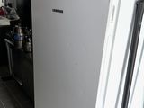 a white refrigerator in the kitchen with the door open