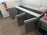 a kitchen with a stove, sink, and refrigerator in it