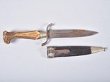 two different types of knives on a white surface