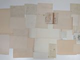 a lot of old papers on the wall and on the floor