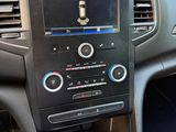 the dashboard of a car with a radio and a steering control