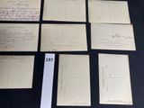 several old postcards are sitting on a table with a black table cloth