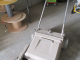 a mop that is sitting on the floor in the garage