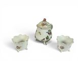 three pieces of porcelain on a white surface