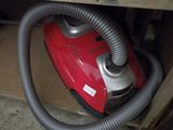 a red and silver vacuum that is sitting in a box