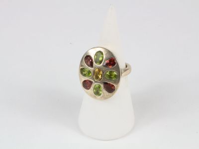 a close up of a silver ring with multi colored stones on it