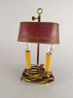 an image of a table lamp with a red shade on top of it