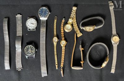 a lot of watches that are laying out on the table
