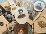 many old photos of women and men on the table