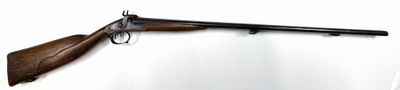 rifle mounted on a wall in a room with a white background