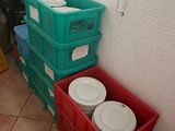 several plastic containers are stacked on top of each other in a room