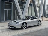 a silver sports car parked in front of a building