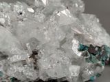 some white crystals with blue and black speckles on top of them