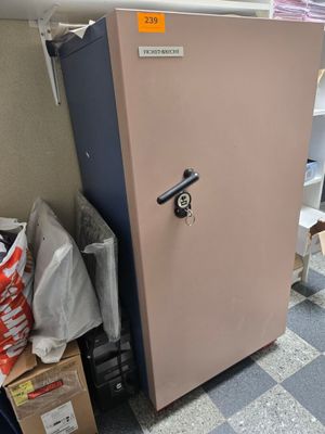 a pink refrigerator sitting in a room with a checkered floor