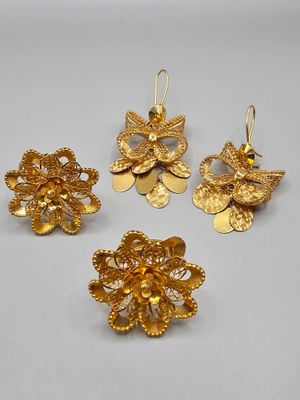 a set of three gold - plated flower earrings and a broochet