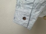 a close up of a button on a shirt on a mannequin head
