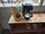 a coffee maker and a coffee pot on a table