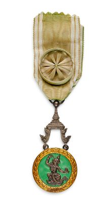 une image représentant une médaille d'or ornée d'un médaillon vert