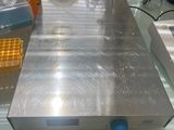 a metal plate on a glass table with other items on it